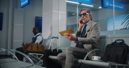 International Airport Terminal: Serious Entrepreneur Irritated About Flight Delay Talking on Phone, Holding Airplane Ticket. Successful Businessman Sitting in Departure Lounge, Going on Business Trip.