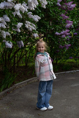 blonde girl posing in blooming lilac