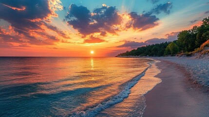 A beautiful sunset over the ocean with clouds and a sandy beach with a forest in the distance