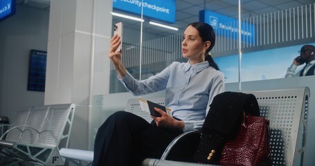 Airport Terminal: Female Entrepreneur Talking to Investor on Smartphone by Video Chat. Successful...