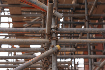 Scaffolding structure supporting construction project with intricate pipe connections and clear...