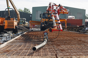 Mobile concrete pump set on construction site ready for pouring concrete slab © Iryna