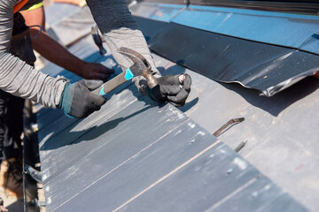 Craftsman roofer builds new house roof from ceramic tiles