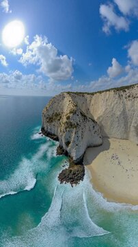 Aerial view of a beach, cliff above the water - 360 loop video