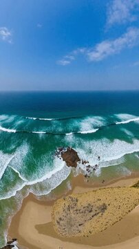 Aerial view of a beach, cliff above the water - 360 loop video