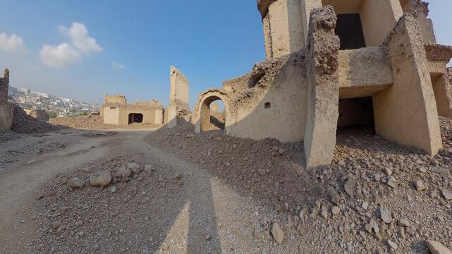 Destroyed buildings in the streets of a city, clear sky, war torn city - 360 loop video