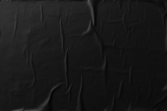Crumpled black paper texture, glued poster pattern with wrinkles for mockup, abstract background