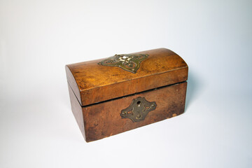 Antique wooden tea caddy isolated on white background. Vintage decorative box used for storing tea, featuring classic craftsmanship and historical charm. Ideal for heritage and collectible themes.