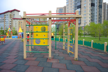 Krasnoyarsk, Russia - May 13, 2025: children's playground with slides, swings and stairs in a modern residential area