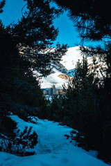 Vall de Nuria Monastery, Spain, hidden among the trees of the forest in the snowy mountains.