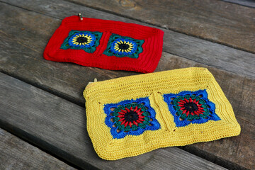 A vibrant crochet piece showcases meticulous hook work. Floral motifs, arranged in squares,...