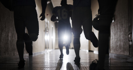 Group, football and running and team in corridor for sports competition, stadium match and game. Fitness, pro league player and athlete with people in tunnel for training, tournament and contest © peopleimages.com