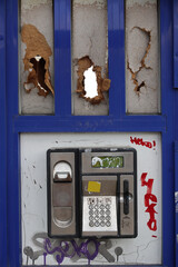 An old broken street phone without a handset.