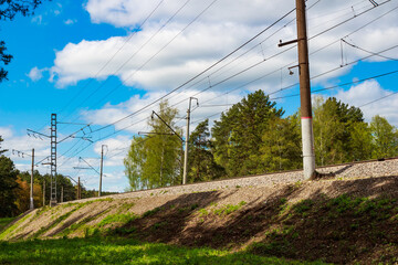 Fototapeta premium Railway embankment with electrified railway tracks