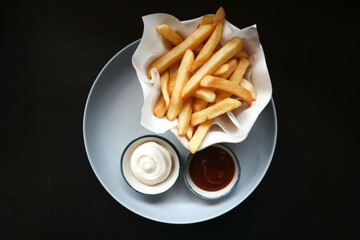  French fries or fried potato , fries with keychup and cheese dip