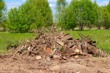 Clearing the area of trash, branches and boards