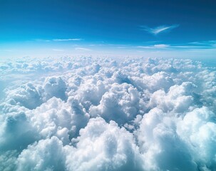 Fototapeta premium Expansive View of Soft White Clouds Against a Bright Blue Sky During Daytime Light