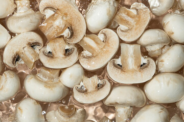 Raw White Mushrooms Champignons Close-Up Splash in a Water Top View