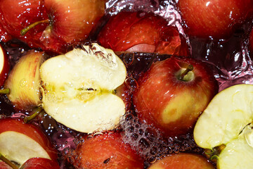 Juicy Whole and Cut Red Apples Close-Up in Water Splash Top View