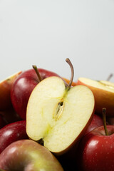 Group of fresh red whole apples and apple halves close-up.