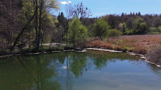 Stunning aerial view of Spiegelweiher serene lake chain near Grafing bei Muenchen, Bavaria, Deutschland. Crystal clear waters, lush spring greenery and trails create perfect scene for nature lovers. 