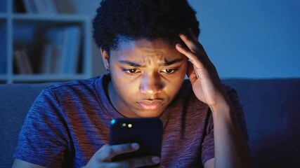Worried teenager using cell phone.