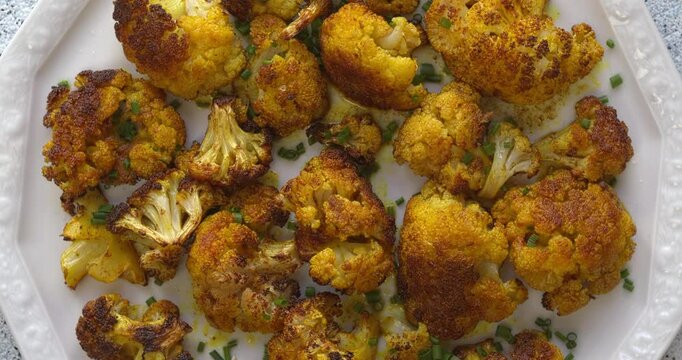 Turmeric Roasted Cauliflower on a serving plate. Great healthy snack.