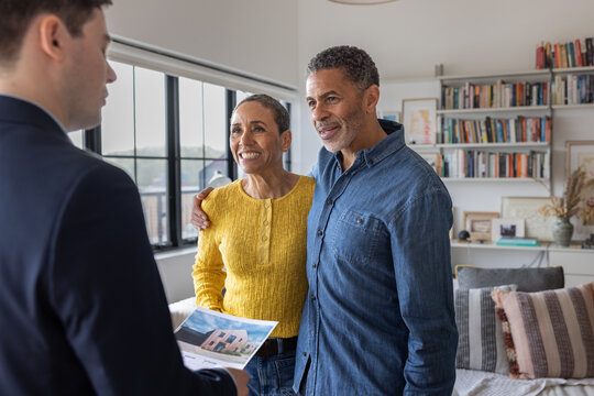 Couple Celebrating Home Choices with Advisor