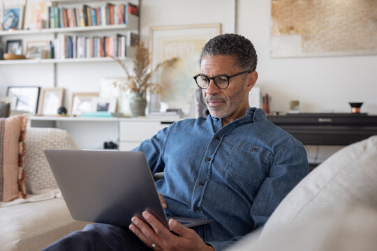 Man Working on Laptop in Cozy Living Room