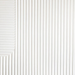 Obraz premium White grooving wall backdrop. Abstract white striped geometric wall covering.