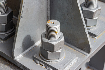 Large nuts on the mounting of the metal support of the power line