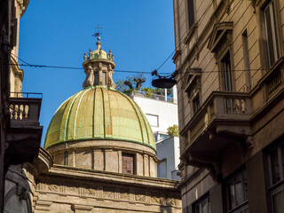 Fototapeta premium Historic buildings along via Lupetta in Milan, Italy, with dome of the San Sebastiano church