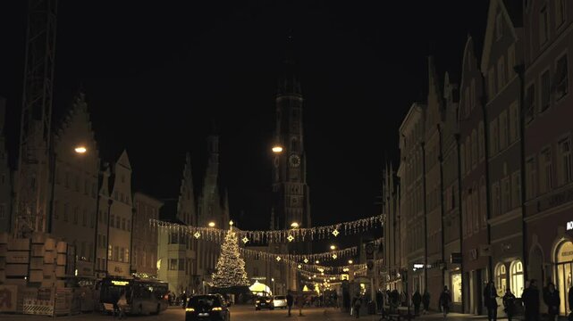  Landshut, Germany. Advent Town Landshut In evening, old city center shines with festive lights as visitors enjoy Christkindlmarkt and artisan craft market in magical atmosphere
