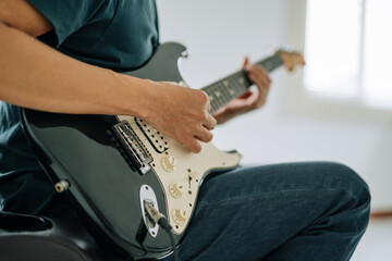 Electric Guitar Solo: A musician's hands dance across the fretboard, coaxing melodies from an electric guitar with skillful precision. Close-up focus on musical passion, musical talent.