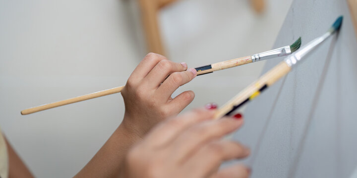 Creative activity with mother and daughter painting together