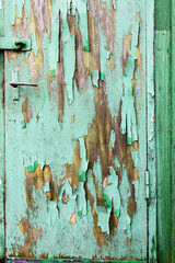Peeling paint on a wooden door outside