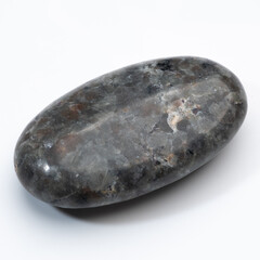 Polished Yooperlite Stone: A captivating dark gray pebble with iridescent blue flashes, showcasing...