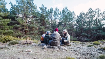 Hikers resting and enjoying the mountain view in winter forest
