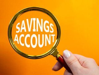 Savings Account symbol. Magnifying Glass with Concept word Savings Account. Businessman hand....