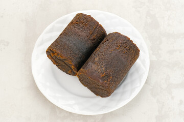 Cylindrical Brown palm sugar, food ingredient
