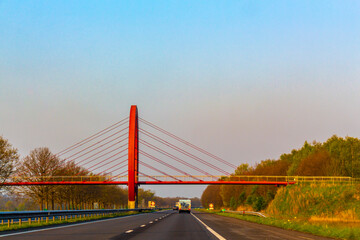 Fototapeta premium Driving on the highway with bridges between tree avenues Netherlands.
