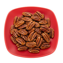 Fototapeta premium A vibrant red plate filled with roasted pecans, showcasing their rich texture and color