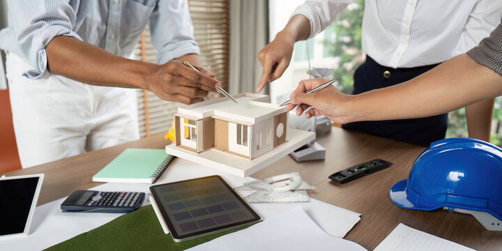 Sustainability engineer team collaborating on architectural model design