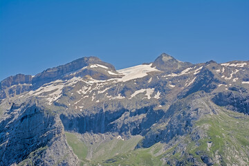 Fototapeta premium Granite alpine mountain top with glacier on a sunny day with clear blue sky in La Vanoise national park, franc
