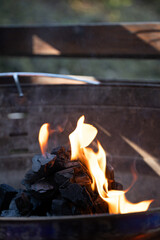 Charcoal burning in outdoor grill with visible flames