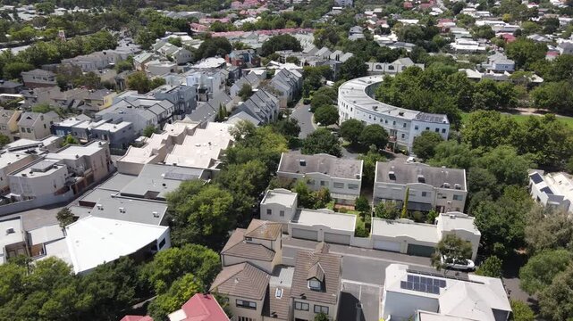 Aerial drone above Kensington suburb with leafy trees on a sunny day