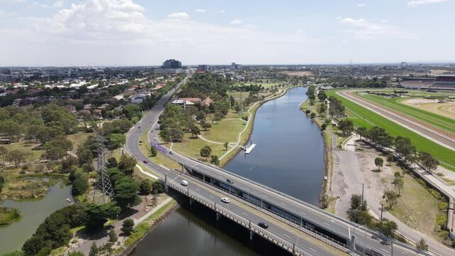 Aerial drone flies over two bridges crossing the Maribyrnong River in Footscray