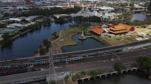 Aerial drone above Metro train in Melbourne on a cloudy day