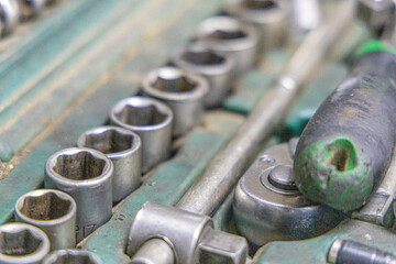 Closeup photo shoot of different nesessary tools and parts in every man's garage.Auto check up and car service shop concept.Different type of tools, especially wrenches.