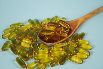 Vitamin capsules on a blue background. Food supplements, dietary supplements